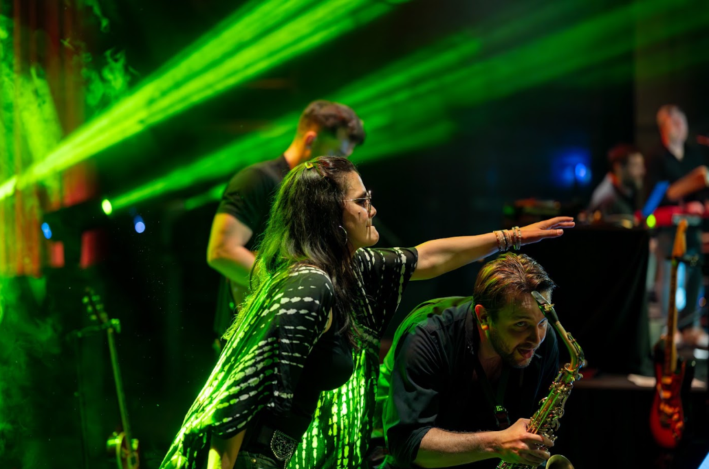 Chanteuse et saxophoniste sous des lasers verts