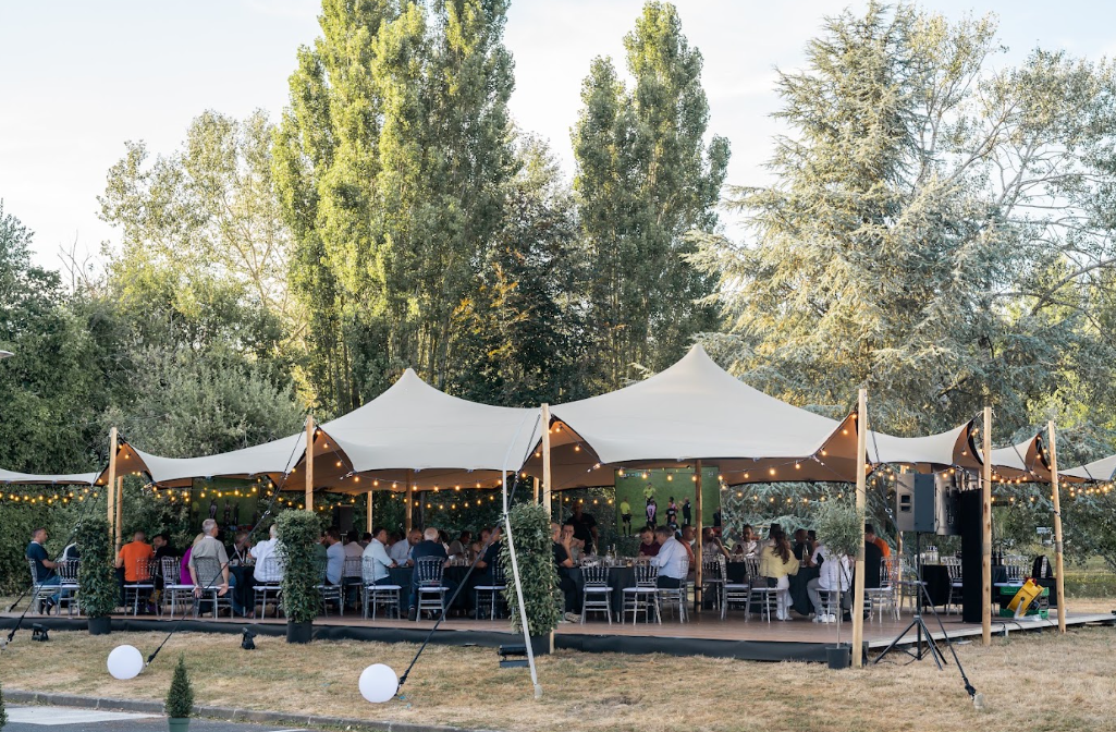 Soirée d'entreprise sous chapiteau avec guirlandes lumineuses